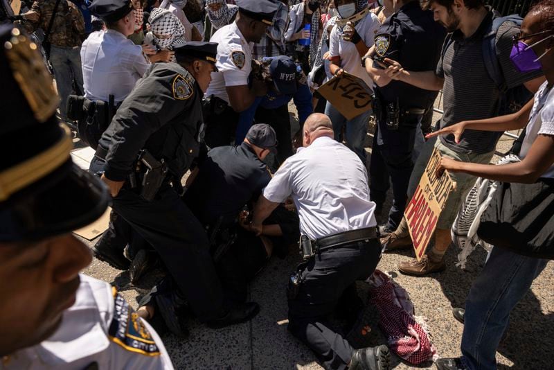 NYPD officers detain a pro-Palestinian supporter as they hold picket line outside Barnard College, Tuesday, Sept. 3, 2024, in New York. (AP Photo/Yuki Iwamura)