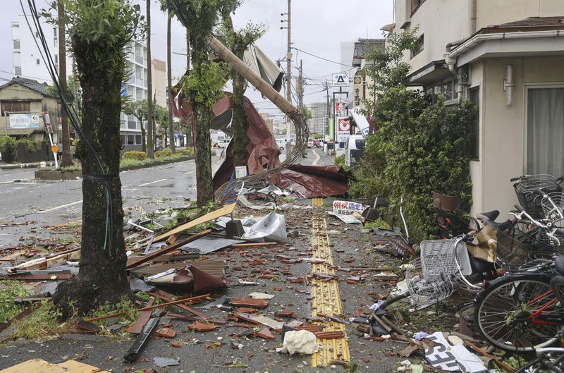 Roof tiles are seen scattered by strong winds of a typhoon at a residential area in Miyazaki, western Japan, Thursday, Aug. 29, 2024. (Kyodo News via AP)