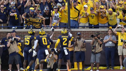 Michigan defensive back Will Johnson (2) celebrates his 42-yard interception for a touchdown against Southern California in the second half of an NCAA college football game in Ann Arbor, Mich., Saturday, Sept. 21, 2024. (AP Photo/Paul Sancya)