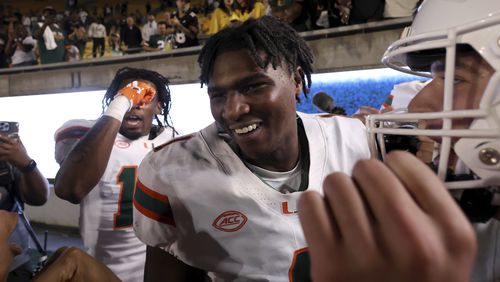 Miami quarterback Cam Ward (1) celebrates after defeating California during an NCAA college football game in Berkeley, Calif., Saturday, Oct. 5, 2024. (AP Photo/Jed Jacobsohn)