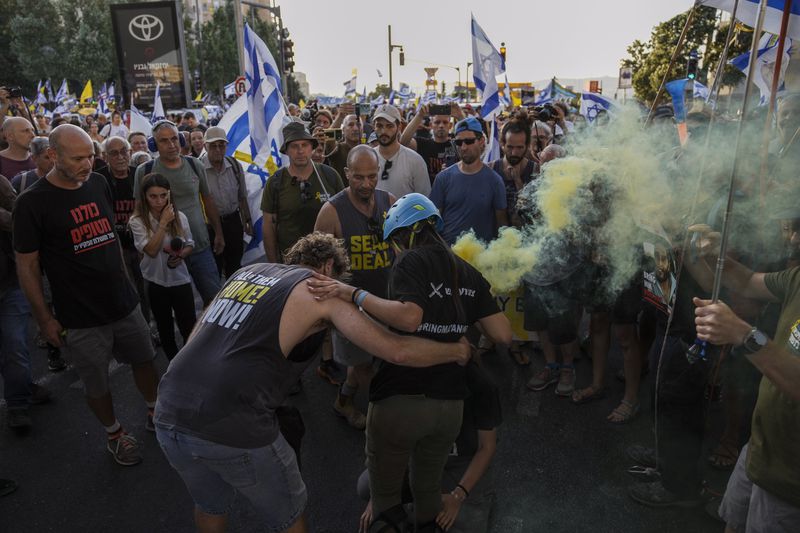 Family members and supporters of the hostages held captive by Hamas in Gaza complete the final leg of a four-day march from Tel Aviv to Jerusalem to demand the immediate release of all hostages in Jerusalem on Saturday, July 13, 2024. (AP Photo/Mahmoud Illean)