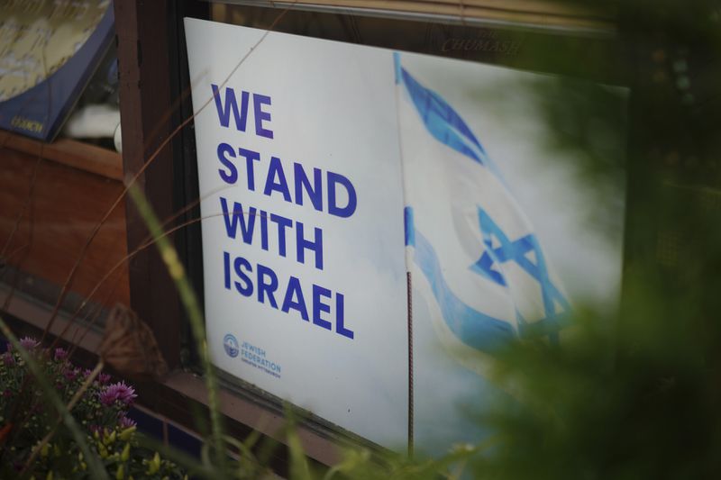 A "We Stand With Israel" sign sits in the window of a local business in Squirrel Hill, the heart of Pittsburgh's Jewish community, Friday, Sept. 27, 2024, in Pittsburgh. (AP Photo/Jessie Wardarski)