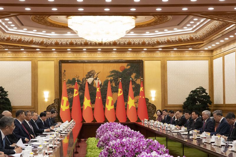 Chinese President Xi Jinping, third left, walks next to Vietnam's President To Lam, second right, attend a meeting at the Great Hall of the People in Beijing Monday, Aug. 19, 2024. (Andres Martinez Casares/Pool Photo via AP)