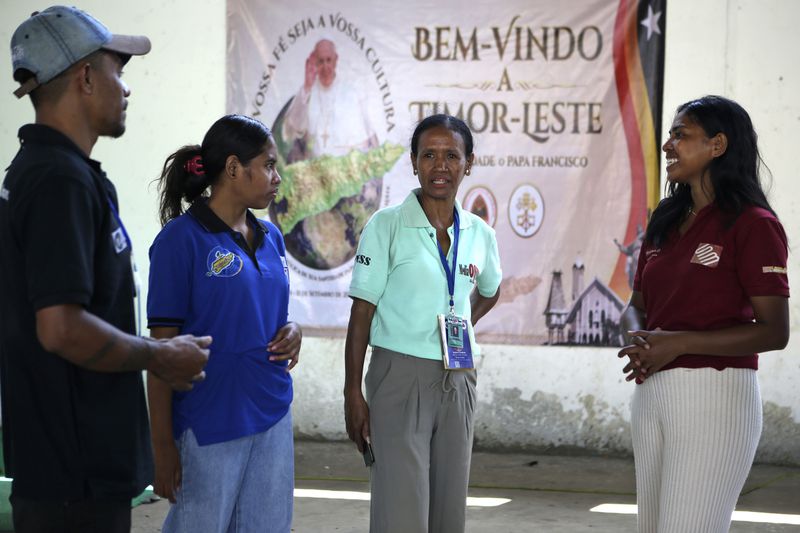 Veteran journalist Suzana Cardoso, second right, speaks with her colleagues at a media center in Dili, East Timor on Saturday, Sept. 7, 2024. (AP Photo/Firdia Lisnawati)