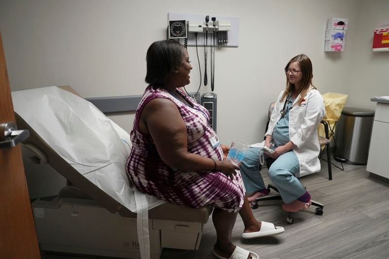 Denise Jones speaks with Dr. Allison Garnett during a prenatal appointment at the Oklahoma State University obstetrics and gynecology clinic in Tulsa, Okla., on Tuesday, July 16, 2024. (AP Photo/Mary Conlon)