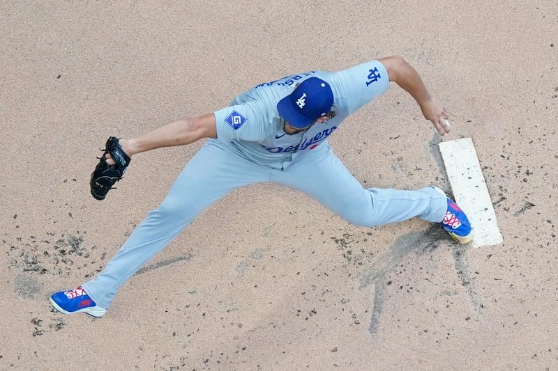 Los Angeles Dodgers' Clayton Kershaw pitches during the first inning of a baseball game against the Milwaukee Brewers, Monday, Aug. 12, 2024, in Milwaukee. (AP Photo/Aaron Gash)