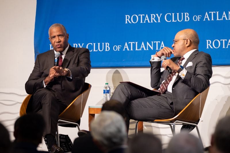 (L-R) Robert F. Smith, founder and CEO of Vista Equity Partners, speaks with Morehouse President David A. Thomas at a Rotary Club event at the Loudermilk Conference Center in Atlanta. In 2019, as Morehouse's commencement speaker, Smith, a billionaire, announced that he was forgiving the student debt of each graduating senior. The gift was estimated to be $40 million. (Arvin Temkar / AJC)