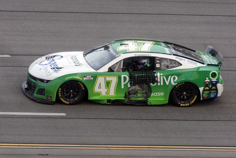 Driver Ricky Stenhouse Jr. drives by the grand stands after winning a NASCAR Cup Series auto race at Talladega Superspeedway, Sunday, Oct. 6, 2024, in Talladega, Ala. (AP Photo/ Butch Dill)