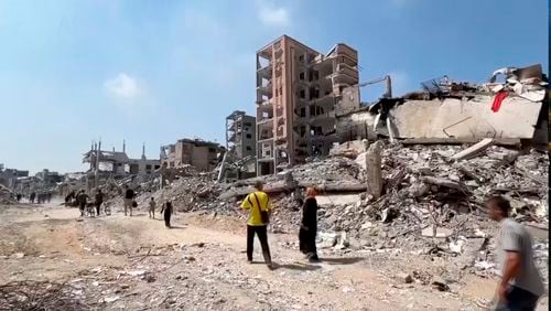 In this image taken from video, Palestinians returned to scenes of destruction in Gaza City's Shijaiyah neighborhood on Thursday, July 11, 2024, after Israeli troops withdrew following a two-week offensive. (AP Photo)