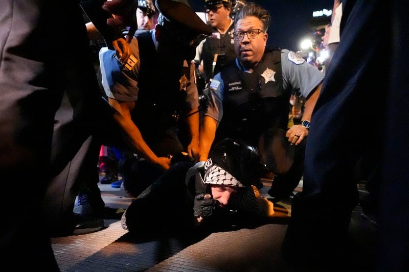 A demonstrators is taken into custody by police police near the Israeli Consulate during the Democratic National Convention Tuesday, Aug. 20, 2024, in Chicago. (AP Photo/Alex Brandon)