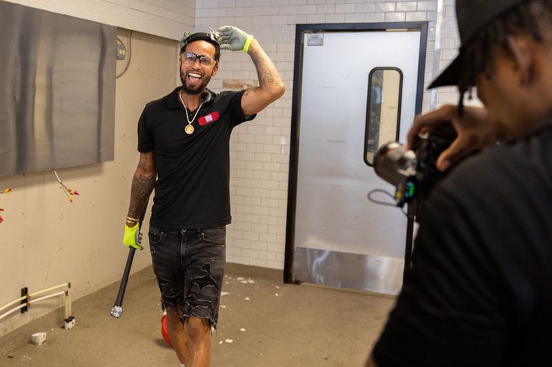 Big Dave’s Cheesesteaks owner Derrick Hayes reacts after a ceremonial wall-breaking ceremony for his restaurant’s new flagship location in Atlanta on Monday, July 29, 2024.  The previous downtown location closed following water main breaks in June that caused damage to several businesses. (Arvin Temkar / AJC)