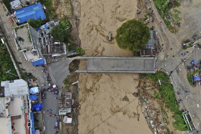 In this aerial image of the Kathmandu valley, Bagmati River is seen in flood due to heavy rains in Kathmandu, Nepal, Saturday, Sept. 28, 2024. (AP Photo/Gopen Rai)