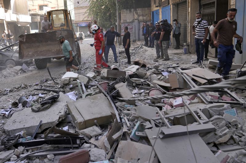 Rescuers arrive at the scene of an Israeli airstrike in Beirut's suburb of Ghobeiri, Sunday, Sept. 29, 2024. (AP Photo/Hussein Malla)