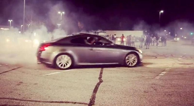 More than 100 people were arrested after gathering in a Sam's Club parking lot to watch street racing, according to police.