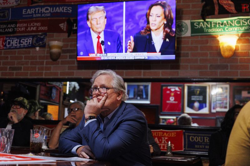 San Francisco Republican party Chair John Dennis watches a presidential debate between Democratic presidential nominee Vice President Kamala Harris and Republican presidential nominee former President Donald Trump at Mad Dog In The Fog on Tuesday, Sept. 10, 2024, in San Francisco. (AP Photo/Juliana Yamada)