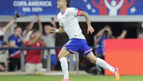 Christian Pulisic of the United States celebrates after scoring his side's opening goal against Bolivia during a Copa America Group C soccer match in Arlington, Texas, Sunday, June 23, 2024. (AP Photo/Julio Cortez)