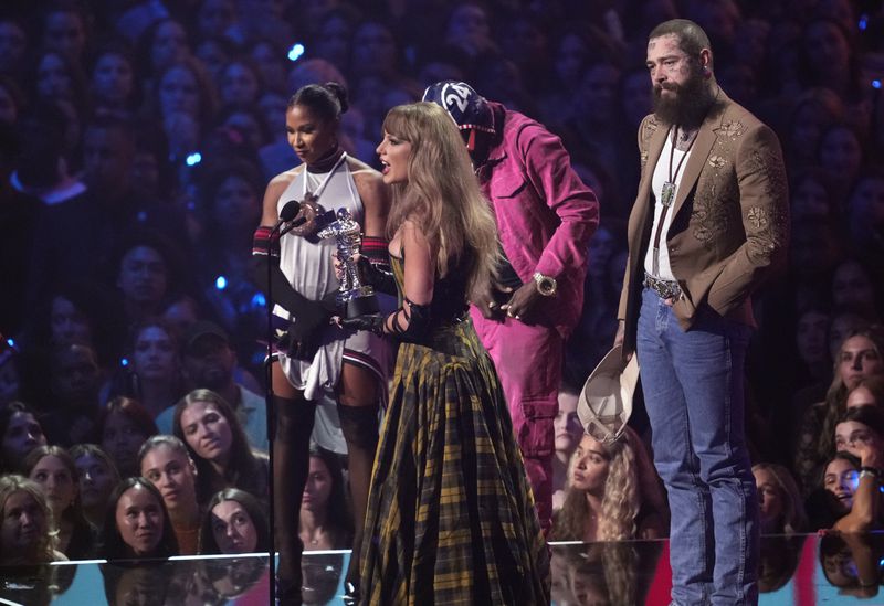 Taylor Swift, center, and Post Malone, far right, accept the award for best collaboration for "Fortnight" during the MTV Video Music Awards on Wednesday, Sept. 11, 2024, at UBS Arena in Elmont, N.Y. (Photo by Charles Sykes/Invision/AP)