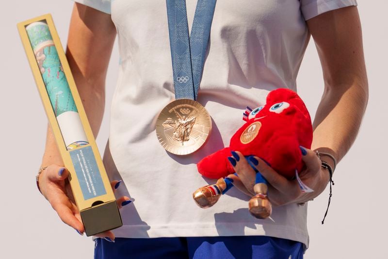 Romanian gymnast Ana Barbosu poses with the bronze medal for her women's artistic gymnastics individual floor performance at the Paris 2024 Olympics, after receiving it during a ceremony at the Romanian Olympic and Sports Committee, in Bucharest, Romania, Friday, Aug. 16, 2024. American gymnast Jordan Chiles called an arbitration panel's decision that dropped her out of the bronze medal position in the floor exercise at the Paris Olympics "unjust" and a "significant blow" in a message posted on social media Thursday. (AP Photo/Vadim Ghirda)