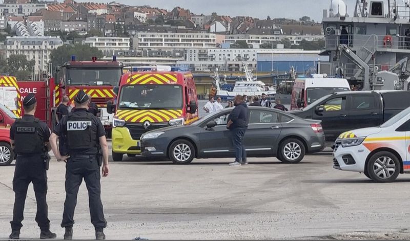 In this grab taken from video provided by BFM Littoral, emergency services at the port of Boulogne-Sur-Mer, France, Tuesday, Sept. 3, 2024, after a boat thought to be carrying migrants ripped apart attempting to cross the English Channel. (BFM Littoral via AP)