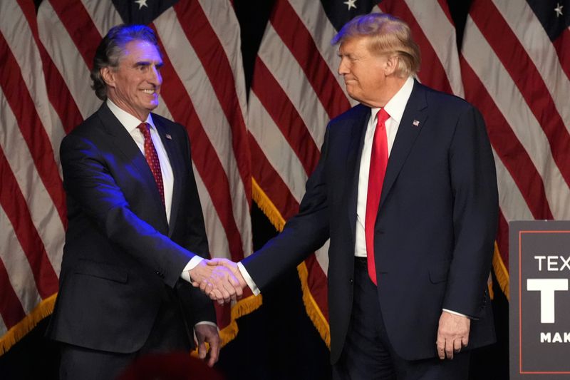 FILE - Republican presidential candidate former President Donald Trump shakes hands with North Dakota Gov. Doug Burgum before he speaks at a caucus night rally in Las Vegas, Feb. 8, 2024. (AP Photo/Mark J. Terrill, File)