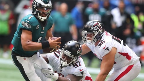 091221 Atlanta: Atlanta Falcons defensive lineman Grady Jarrett (center) and Tyler Davison look to tackle Philadelphia Eagles quarterback Jalen Hurts during the second half in a NFL football game on Sunday, Sept 12, 2021, in Atlanta.    ���Curtis Compton / Curtis.Compton@ajc.com���