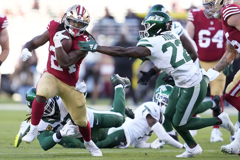 San Francisco 49ers running back Jordan Mason, left, runs against New York Jets safety Tony Adams (22) during the first half of an NFL football game in Santa Clara, Calif., Monday, Sept. 9, 2024. (AP Photo/Godofredo A. Vásquez)