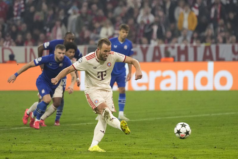 Bayern's Harry Kane scores his sides 7th goal and his 4th of the game from the penalty spot during the Champions League opening phase soccer match between Bayern Munich and GNK Dinamo at the Allianz Arena in Munich, Germany Tuesday, Sept. 17, 2024. (AP Photo/Matthias Schrader)