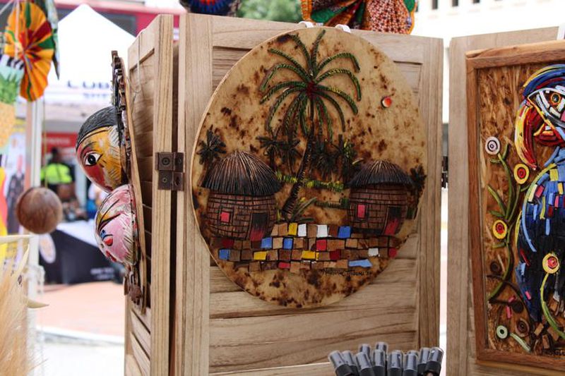Art made out of coconut shells and wood from Nigeria on sale in the GlowAmaze booth at the Marietta Juneteenth Celebration on Saturday. (Photo Courtesy of Isabelle Manders)