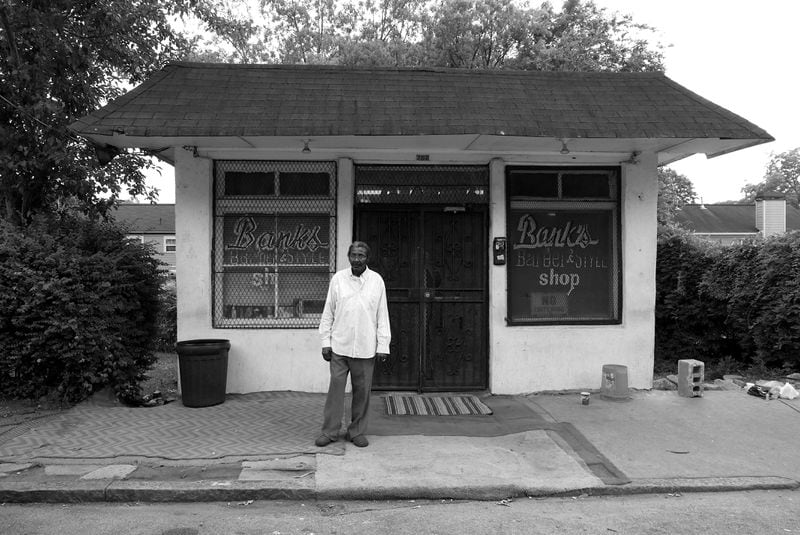 Mr. Willie Banks stands in front of his business, Bank’s Barber Shop in Atlanta, GA in this photo by Atlanta photographer Antonio M. Johnson from his new book "You Next: Reflections in Black Barber Shops."
Courtesy of Antonio M. Johnson