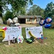 Memorial placards to Harmony Taylor, 7, and Derrick Taylor, 4, who were killed when a tree crashed down on their house on South Hospital Road in Sandersville, Georgia early Friday. (Joe Kovac Jr. / AJC)