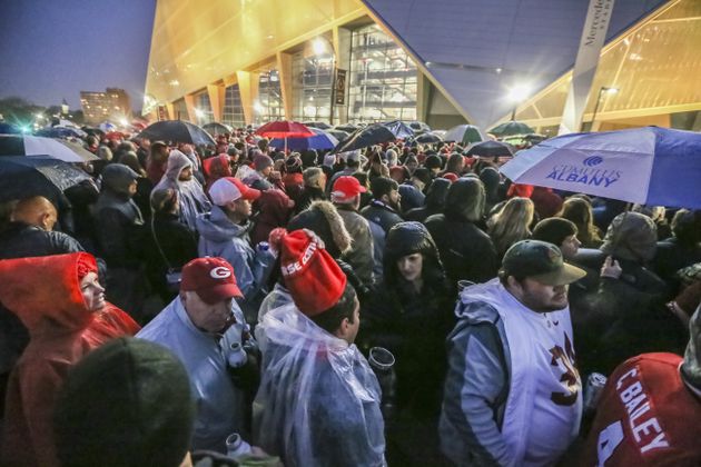 January 8, 2018 Atlanta: Crowds wait to get in the game in downtown Atlanta on Monday, Jan. 8, 2018. The Alabama Crimson Tide were 3.5-point favorites going into Monday night’s College Football Playoff Championship against the Georgia Bulldogs at Atlanta’s Mercedes-Benz Stadium. Gov. Nathan Deal ordered non-essential state offices from Columbus to Augusta and northward to close Monday, and city of Atlanta officials announced a similar order for local offices. Officials began announcing closures to ease traffic burdens early, in large part because of the game. The 8pm kick off for the championship, will see US President Donald Trump in attendance. Kendrick Lamar was scheduled to perform a free halftime concert at Centennial Olympic Park. JOHN SPINK/JSPINK@AJC.COM