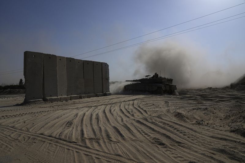 An Israeli tank maneuvers near the Israel-Gaza border in southern Israel, Friday, July 12, 2024. (AP Photo/Tsafrir Abayov)