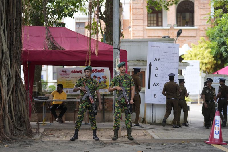 Police commandos stand guard outside a ballot counting center in Colombo, Sri Lanka, Saturday, Sept. 21, 2024. (AP Photo/Eranga Jayawardane)