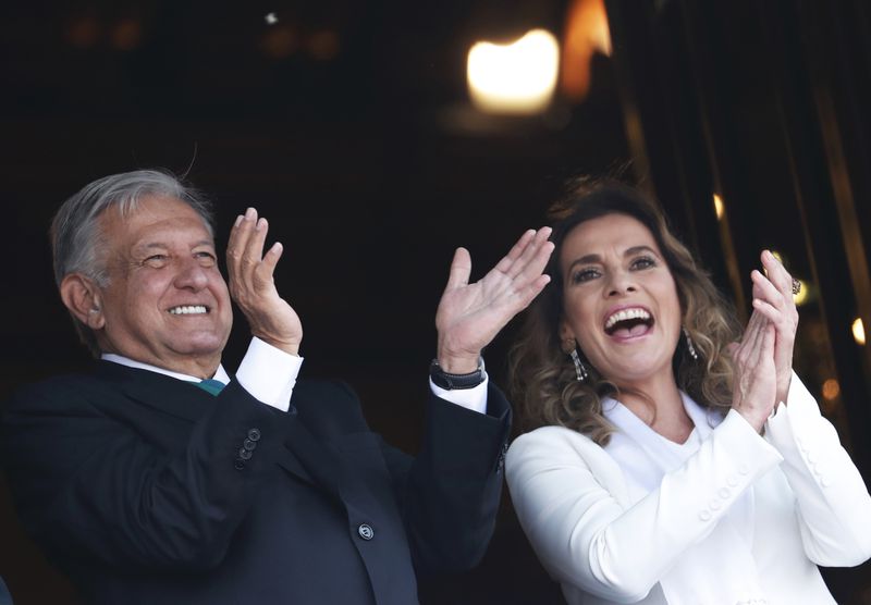 FILE - Mexican President Andres Manuel Lopez Obrador and first lady Beatriz Gutierrez Muller greet the crowd during an Independence Day military parade at the Zocalo in Mexico City, Sept. 16, 2019. (AP Photo/Marco Ugarte, File)