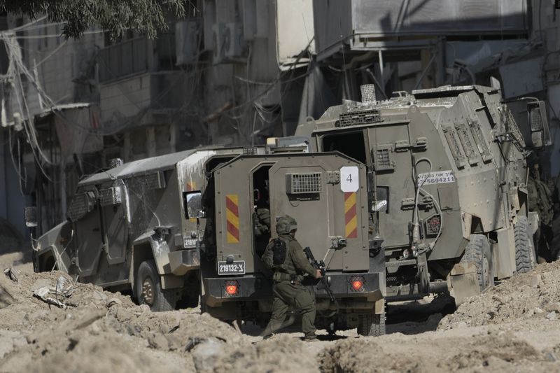 Members of Israeli forces patrol a street during a military operation in the West Bank refugee camp of Nur Shams, Tulkarem, Thursday, Aug. 29, 2024. (AP Photo/Majdi Mohammed)