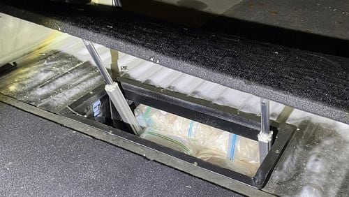 In this undated photo provided by the Australian Federal Police, illicit drugs are found in a concealed compartment in a vehicle after police have revealed on Wednesday, Sept. 18, 2024, that they have penetrated an encrypted global communications app developed for criminals called Ghost, leading to dozens of arrests. (Australian Federal Police via AP)