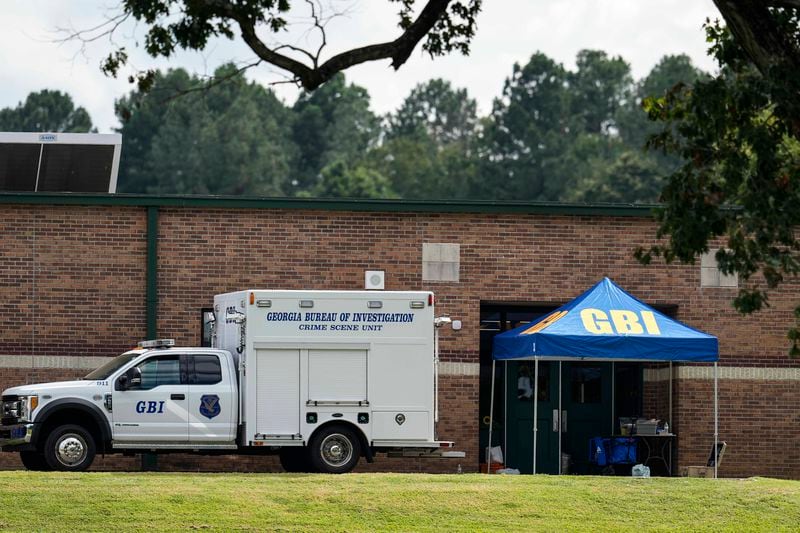 Georgia Bureau of Investigation staff move through an entrance to Apalachee High School after Wednesday's shooting, Thursday, Sept. 5, 2024, in Winder, Ga. (AP Photo/Mike Stewart)