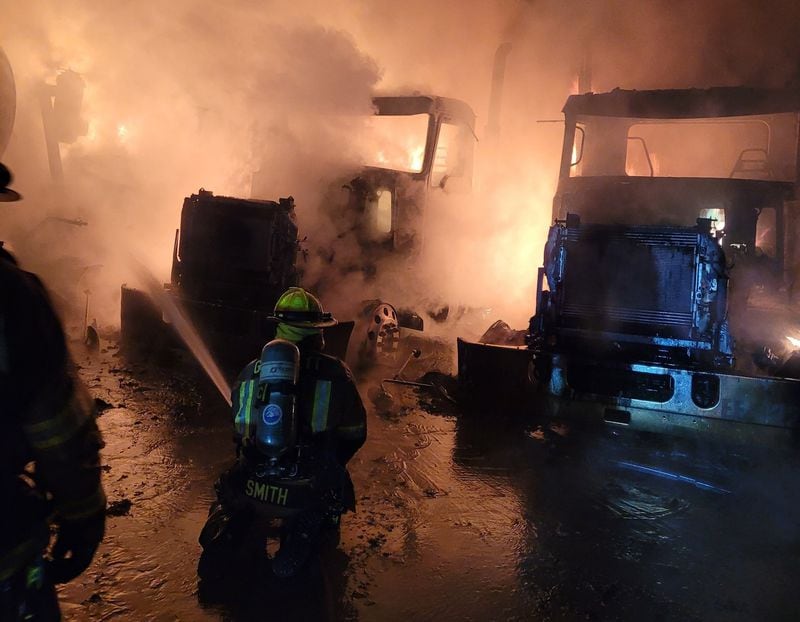 Multiple work vehicles owned by Ernst Concrete were found burning behind the business Tuesday, Nov. 14, 2023. Fire officials said they believe arson to be the cause. (Gwinnett County Fire and Emergency Services)