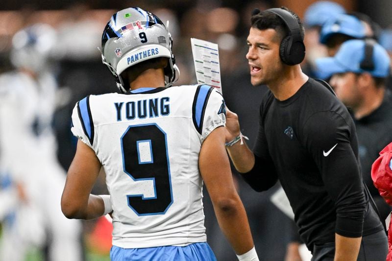 Carolina Panthers head coach Dave Canales right talks to quarterback Bryce Young (9) during the second half of an NFL football game against the New Orleans Saints, Sunday, Sept. 8, 2024, in New Orleans. (AP Photo/Matthew Hinton)