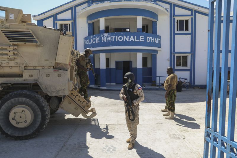 Haitian and Kenyan police who are part of a UN-backed multinational force stand at a police station in Pont-Sonde, Haiti, Monday, Oct. 7, 2024, days after a gang attacked the town. (AP Photo/Odelyn Joseph)