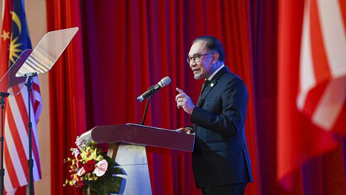 In this photo released by Malaysia's Department of Information, Malaysian Prime Minister Anwar Ibrahim speak during a business luncheon with China's Premier Li Qiang at a hotel in Kuala Lumpur, Malaysia, Thursday, June 20, 2024. (Malaysia's Department of Information via AP)