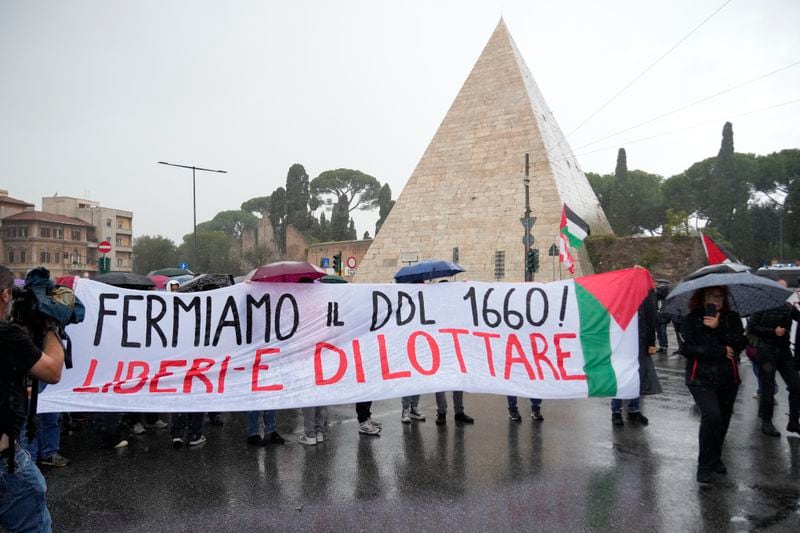 People stand during a protest in Rome, Saturday, Oct. 5, 2024. Pro-palestinians people take to the street in an unauthorised march in the centre of Rome two days ahead of the first anniversary of the Oct. 7. (AP Photo/Andrew Medichini)