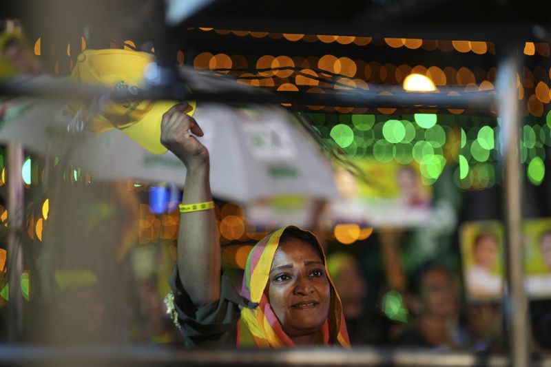 A woman listens to Sajith Premadasa, unseen, the presidential candidate and opposition leader of the Samagi Jana Balawgaya or United People's Power party, at an election rally, in Colombo, Sri Lanka, Wednesday, Sept. 18, 2024. (AP Photo/Rajesh Kumar Singh)