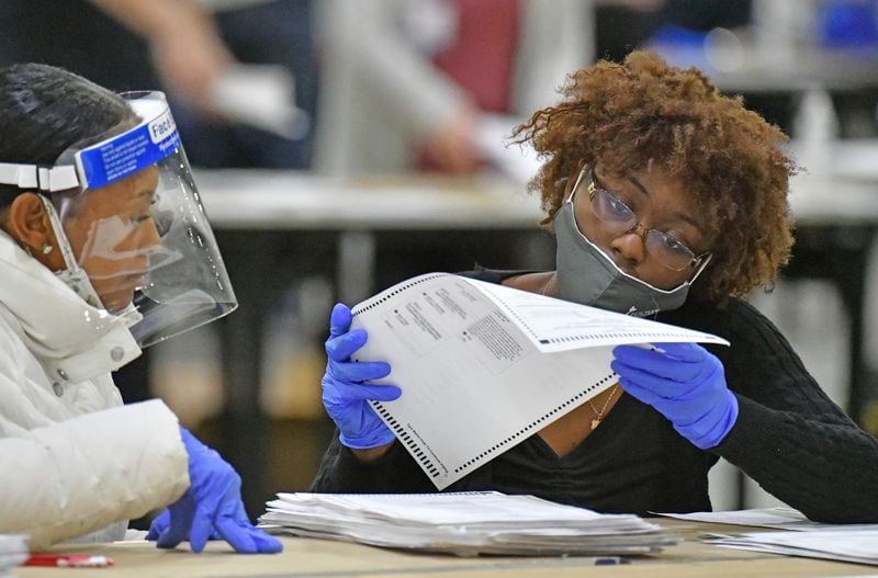 Members of a Fulton County recount team work on an audit of ballots following the 2020 presidential election. The statewide audit confirmed that Democrat Joe Biden defeated Republican President Donald Trump in Georgia by about 12,000 votes. (Hyosub Shin / Hyosub.Shin@ajc.com)