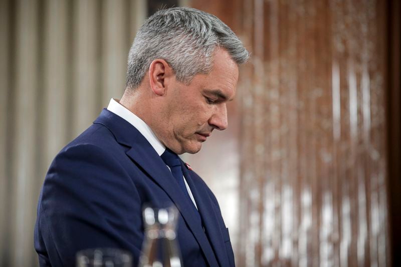 Austrian Chancellor Karl Nehammer stands at the national broadcaster studio, set up in the parliament building, in Vienna, Austria, Sunday, Sept. 29, 2024, after polls closed in the country's national election. (AP Photo/Heinz-Peter Bader)