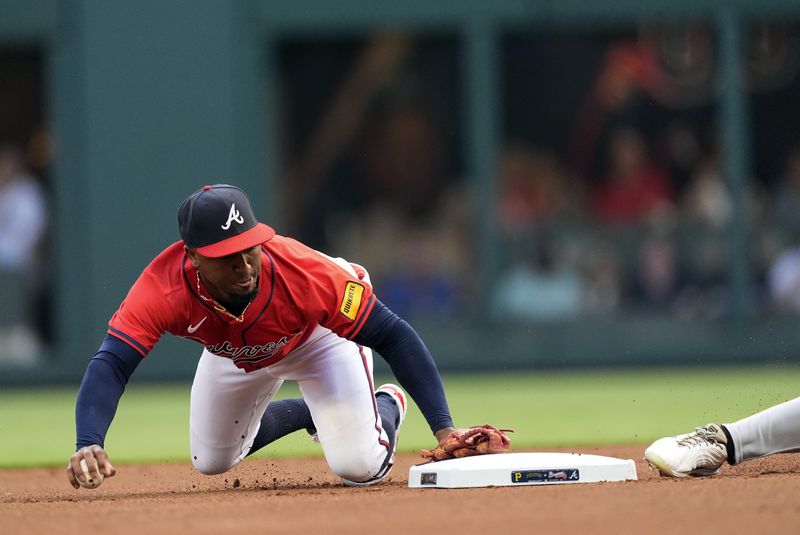 Atlanta Braves second base Ozzie Albies (1) forces out Pittsburgh Pirates' Bryan Reynolds (10) on a ground ball from Oneil Cruz inning of a baseball game Friday, June 28, 2024, in Atlanta. (AP Photo/John Bazemore)