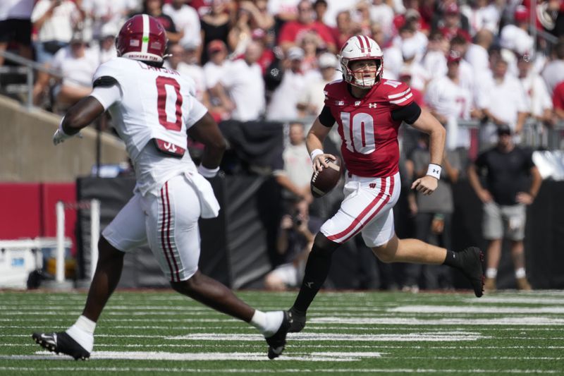 Wisconsin's Tyler Van Dyke (10) runs during the first half of an NCAA college football game against Alabama Saturday, Sept. 14, 2024, in Madison, Wis. (AP Photo/Morry Gash)