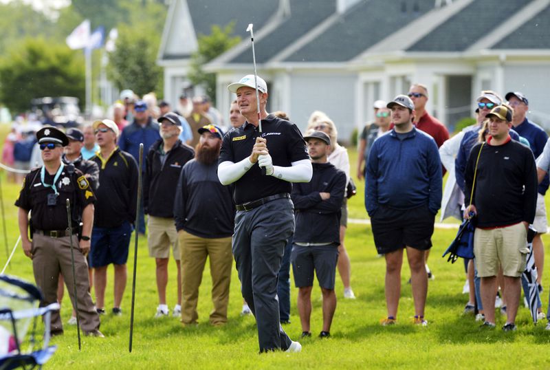 Ernie Els hits from the rough on the first hole during the final round of the Senior PGA Championship held at Harbor Shores Sunday, May 26, 2024, in Benton Harbor, Mich. (Don Campbell/The Herald-Palladium via AP)