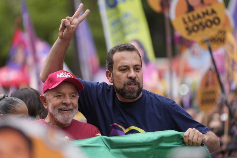 Mayoral candidate Guilherme Boulos of the Socialism and Liberty Party, right, campaigns with Brazilian President Luiz Inacio Lula da Silva the day before elections in Sao Paulo, Saturday, Oct. 5, 2024. (AP Photo/Andre Penner)