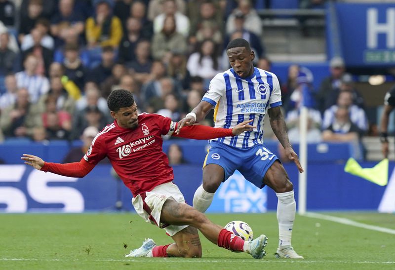 Nottingham Forest's Morgan Gibbs-White, left and Brighton and Hove Albion's Pervis Estupinan vie for the ball, during the English Premier League soccer match between Brighton and Nottingham Forest, at the American Express Stadium, in Brighton and Hove, England, Sunday, Sept. 22, 2024. (Gareth Fuller/PA via AP)